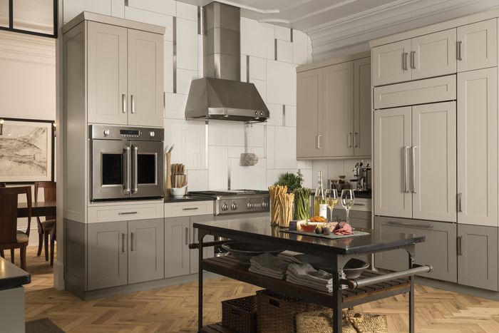 A warm-toned, traditional styled kitchen with french door wall ovens.